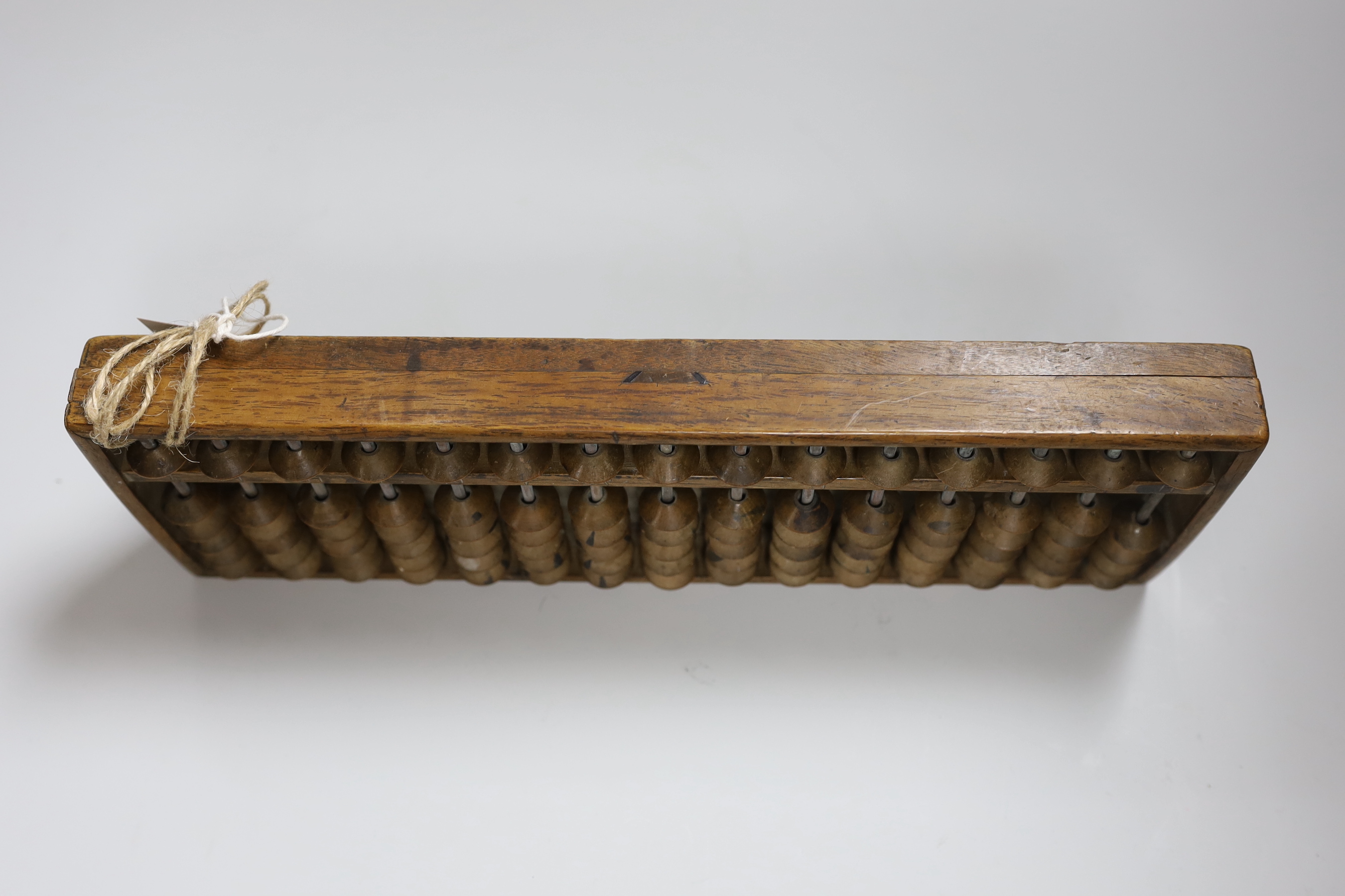 A Chinese abacus, 34cm long